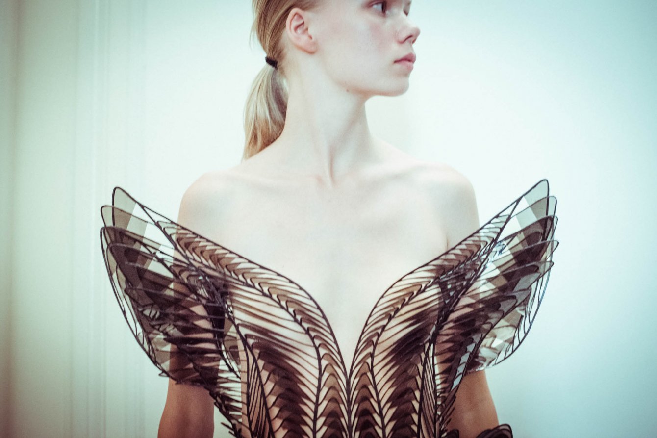 Iris van Herpen Syntopia collection dress inspired by bird flight and kinetic installations, crafted with laser-cut organza and intricate weaving.