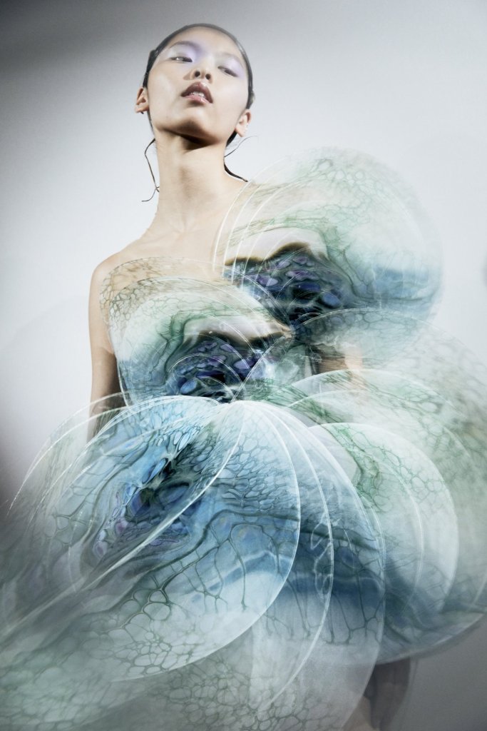 Iris van Herpen couture design combining technology and fashion, with laser-cut textures and futuristic silhouettes inspired by science.