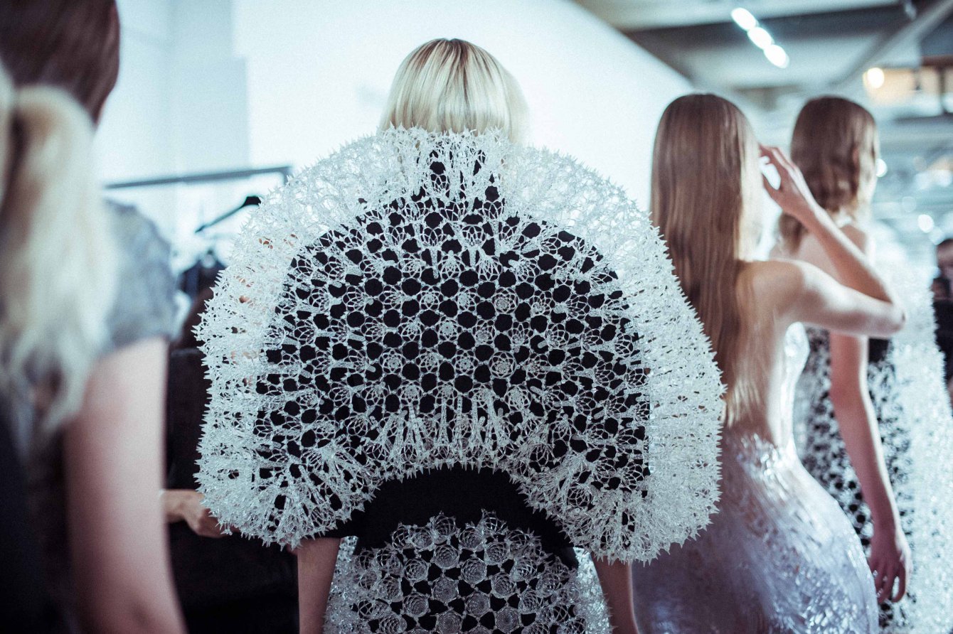 Iris van Herpen couture design combining technology and fashion, with laser-cut textures and futuristic silhouettes inspired by science.